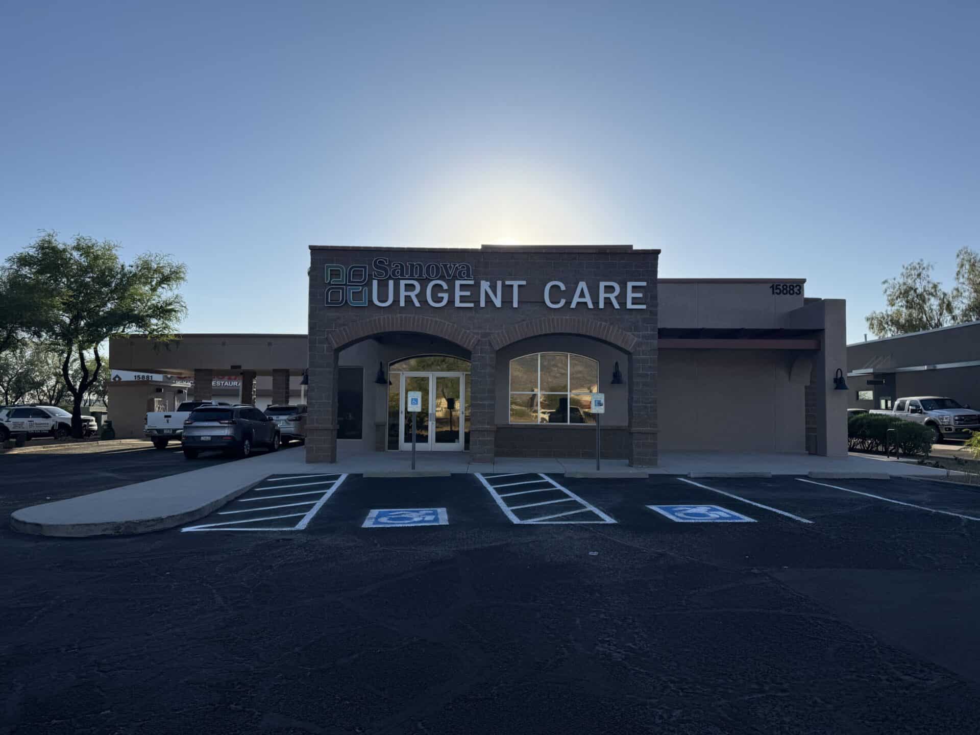 Patient checking in at the front desk of Sanova Urgent Care, discussing self-pay pricing and insurance in Catalina, Arizona