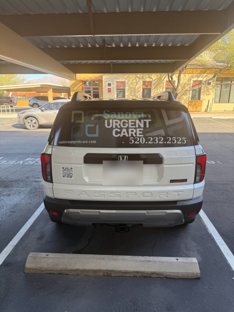Sanova Urgent Care branded vehicle with the clinic phone number 520-232-2525 and website, parked at a Catalina, AZ office