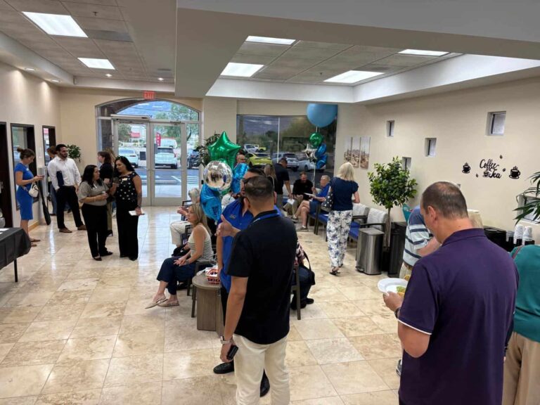 Open house guests in the Sanova Urgent Care waiting area with seating and natural light